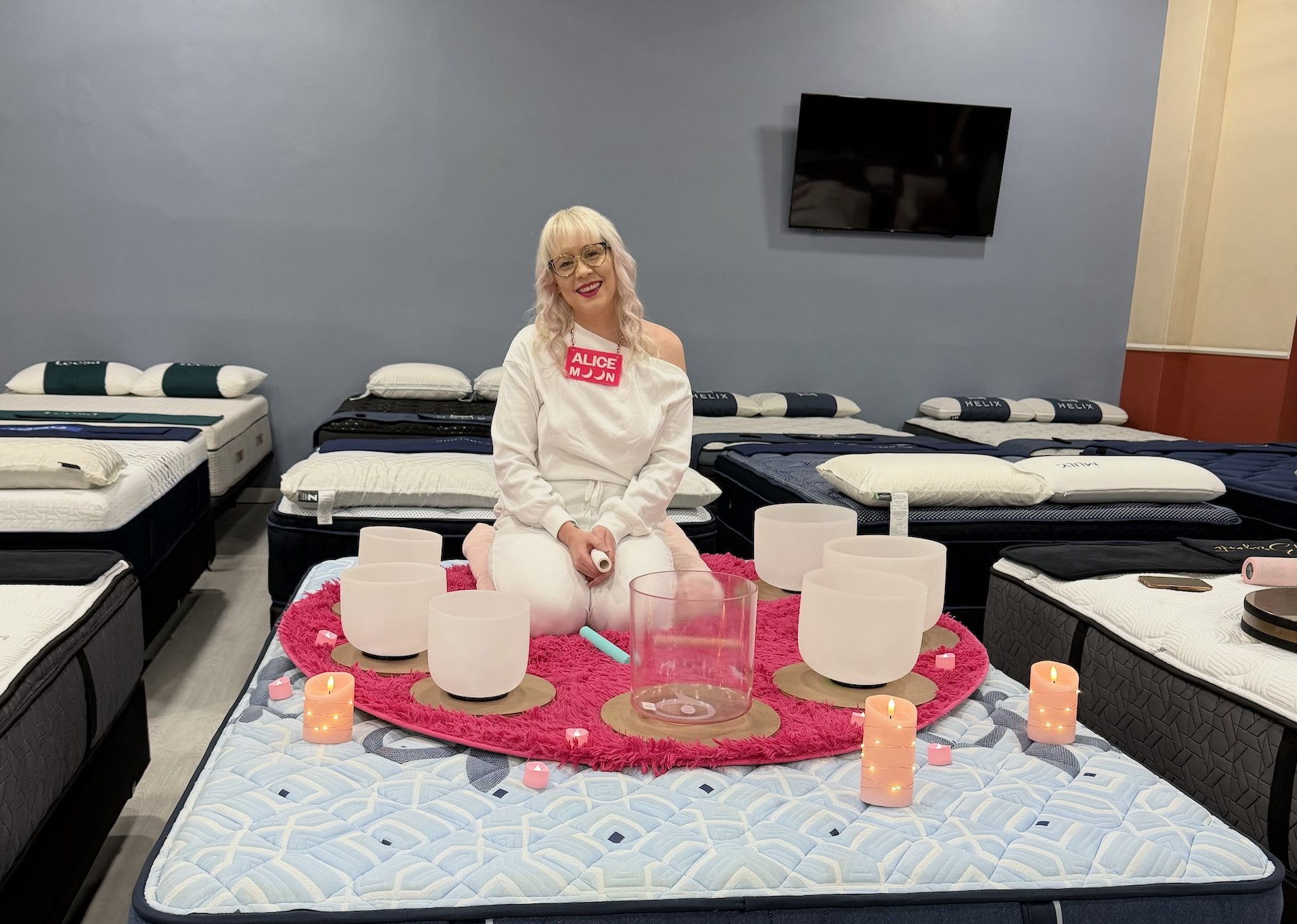 Alice Moon with crystal singing bowls on a mattress at Mattress Central in Atwater Village